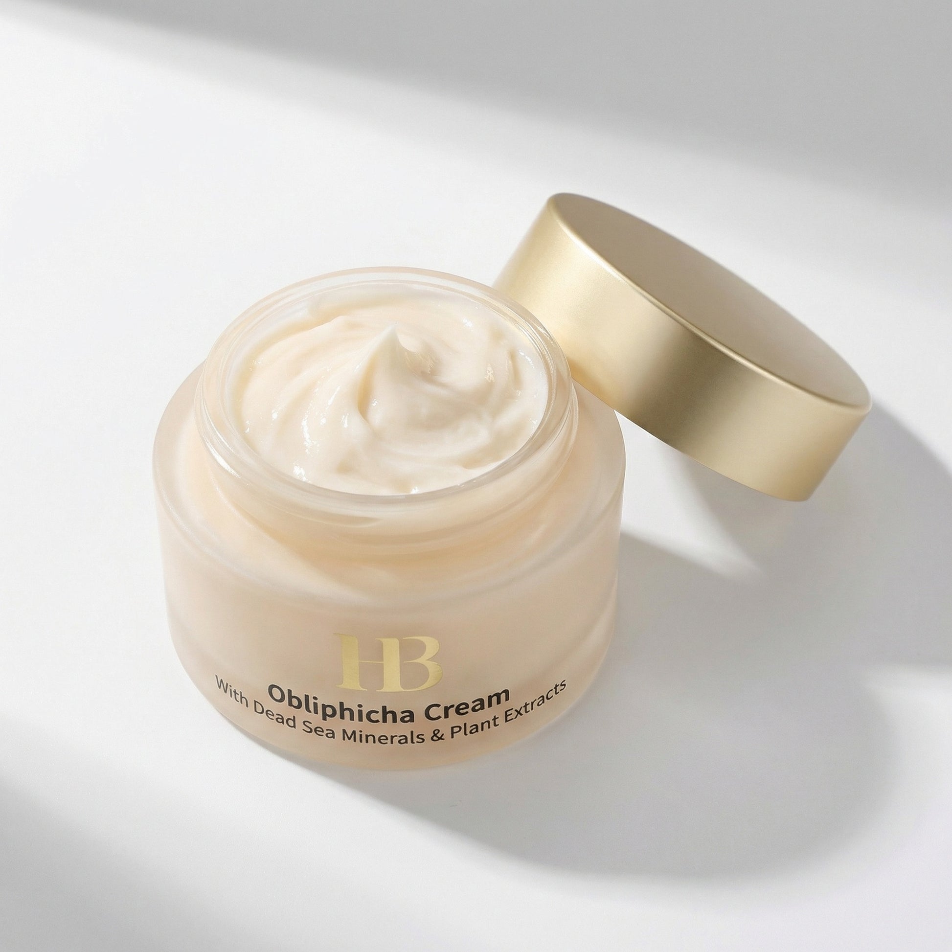 Omphicha Cream jar with gold lid on a light background